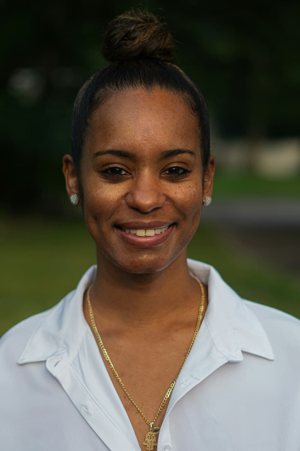 Portrait of a smiling woman in a white blouse