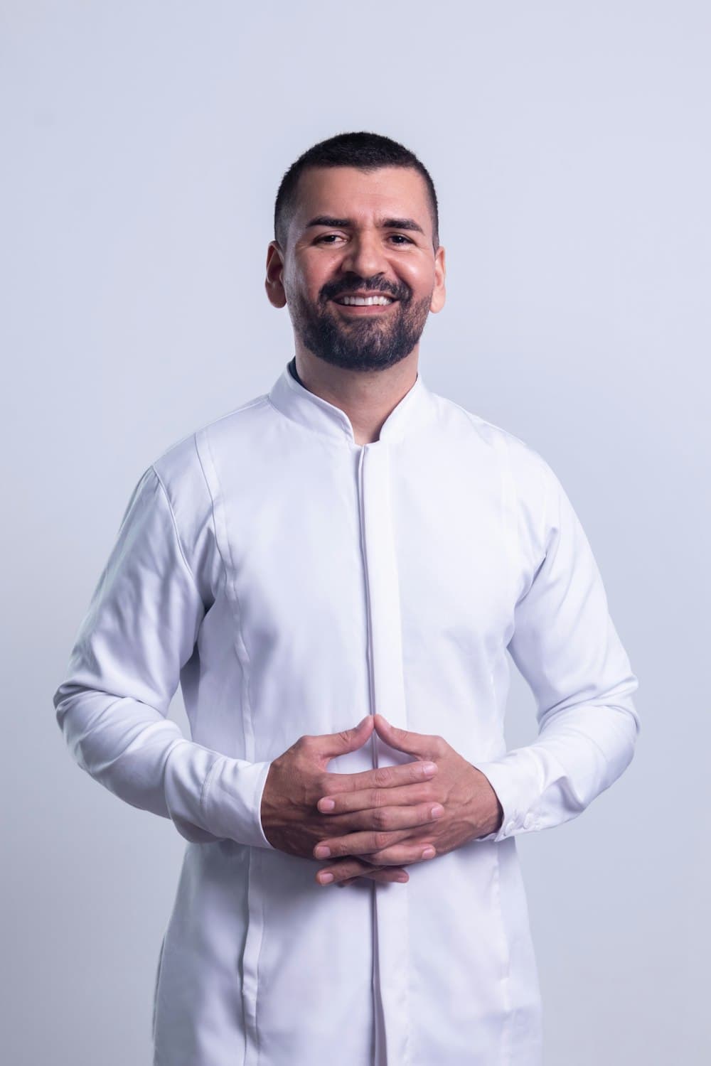 Portrait of a smiling man in a white clinical coat
